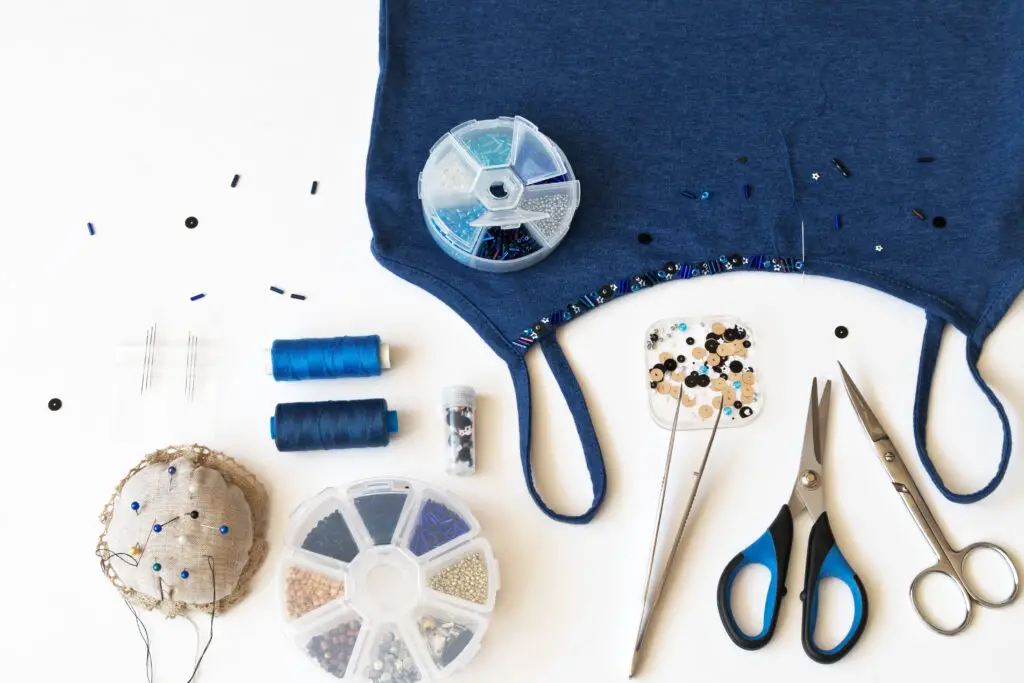 Beadwork and sewing decoration on a blue top