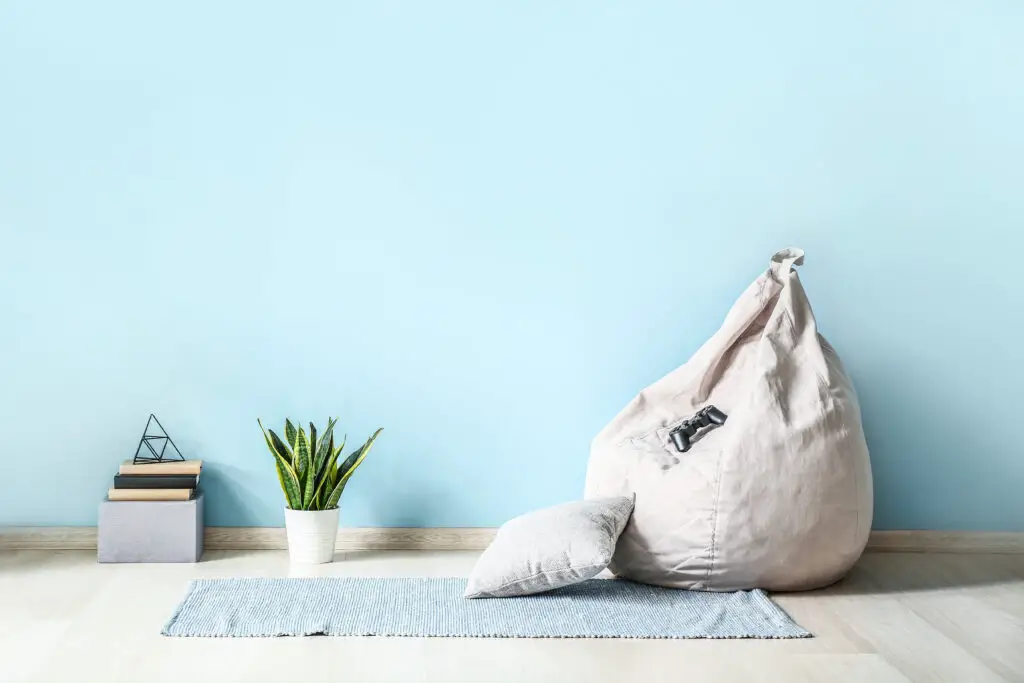 Cream beanbag in a blue room.